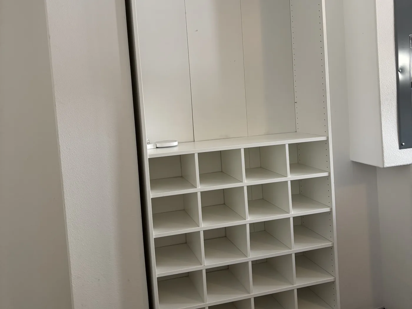 Move-out cleaning with the refrigerator cleaned inside and built-in mudroom cubbies emptied and wiped down