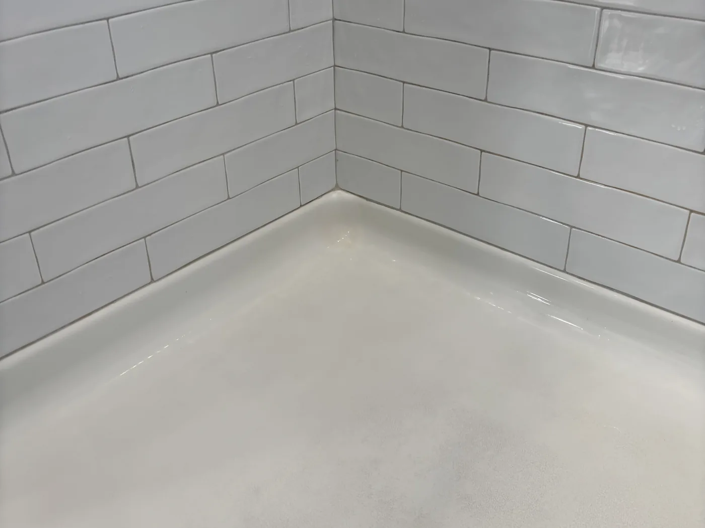 Shower after a deep clean, with white grout lines and the linear drain channel cleaned out