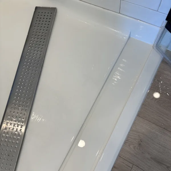 The same linear shower drain back in place, clean and dry