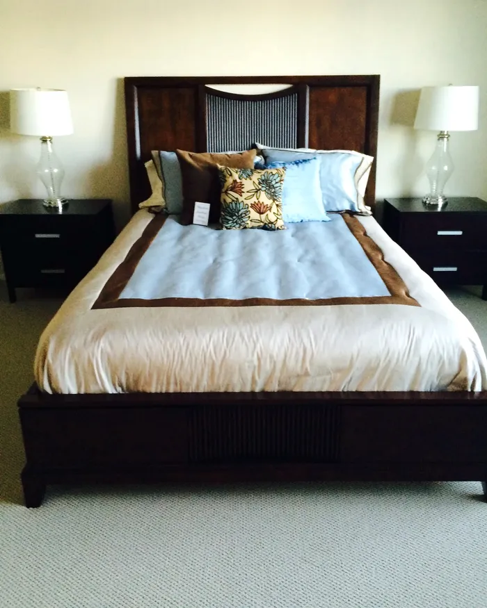 Neatly made bed and tidy bedroom after a visit from White Flowers Cleaning Services