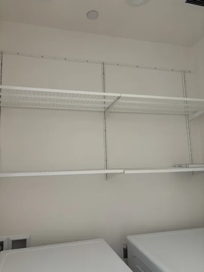 Laundry room shelving and machine tops wiped down and left empty